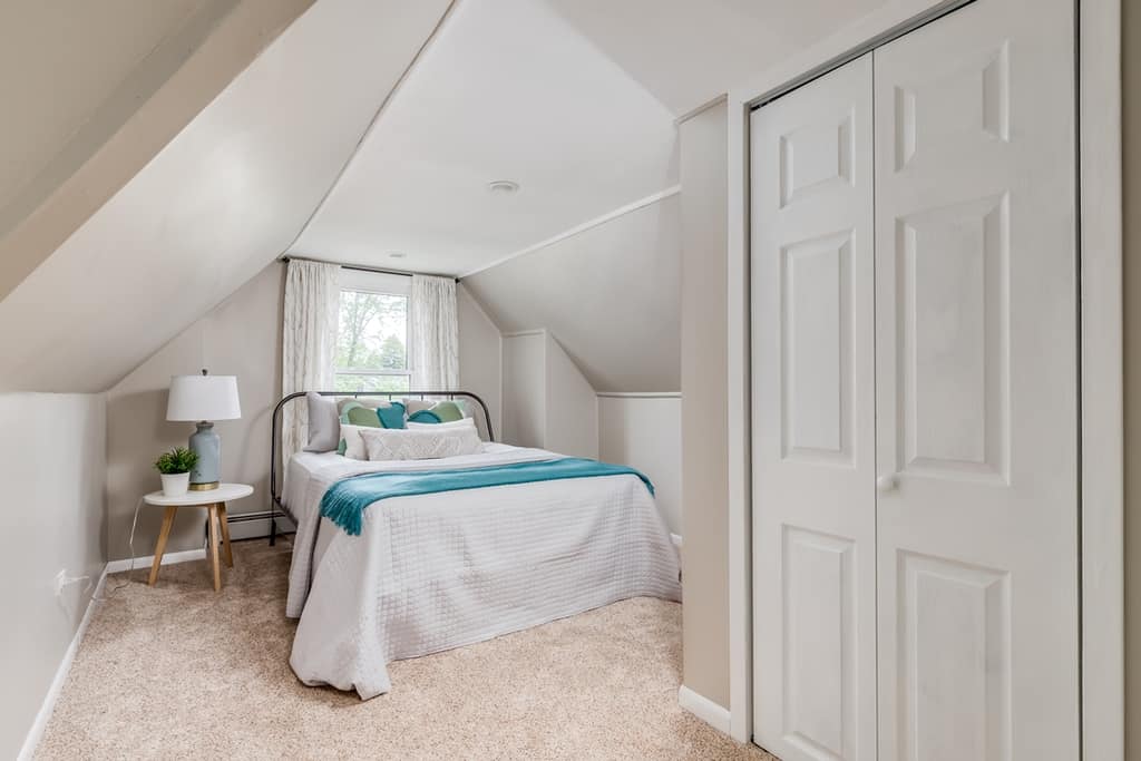 light color painted in the bedroom with slanted walls