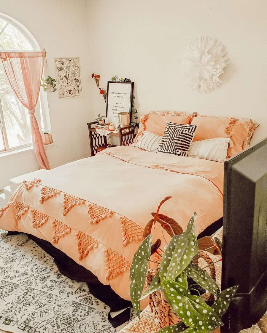 Warm toned bedroom with plants and patterned rug
