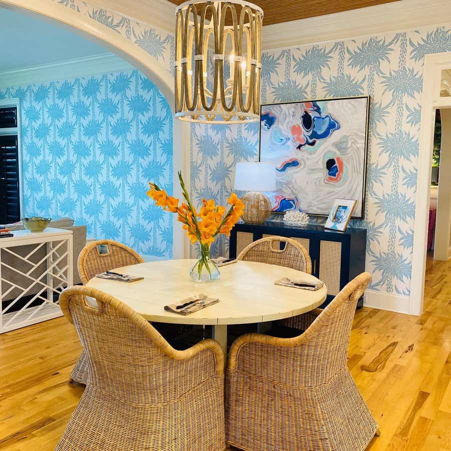 Dining room with wicker chairs and a gold chandelier