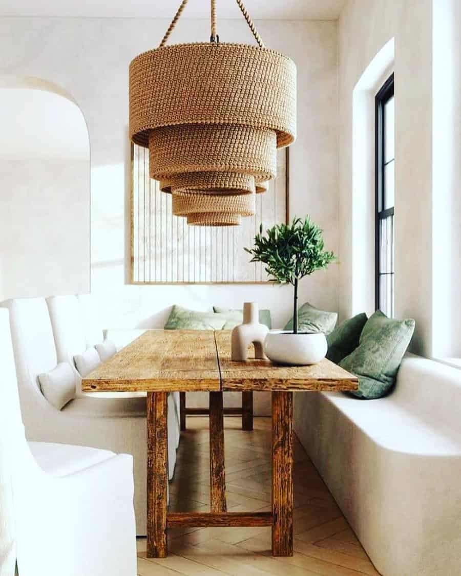 Chic dining space with rustic table and beaded chandelier