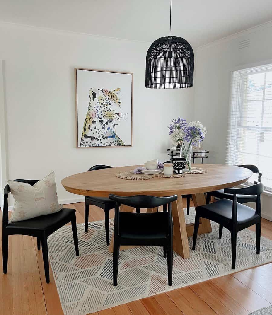 Stylish dining room with art and black accents