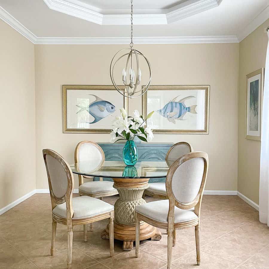 Coastal dining room with orb chandelier and fish artwork