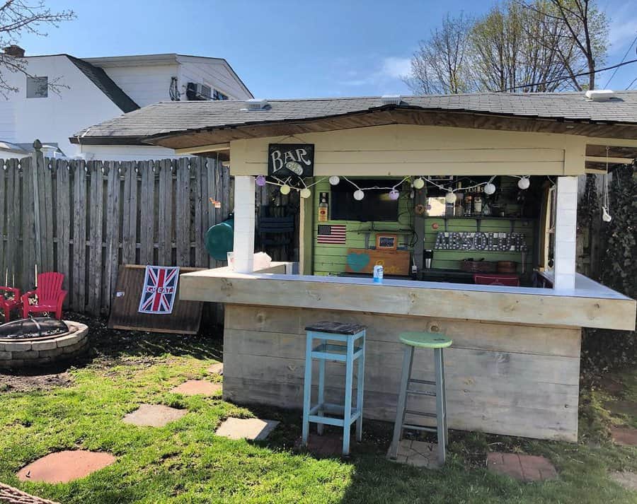 Backyard bar with a British flag and fire pit