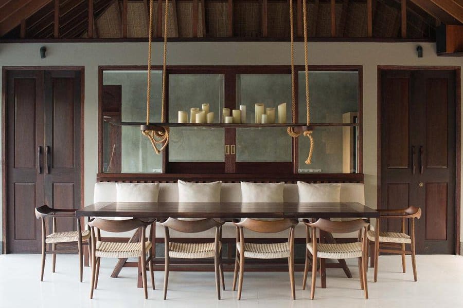 Rustic dining room with rope-suspended table and candle shelf
