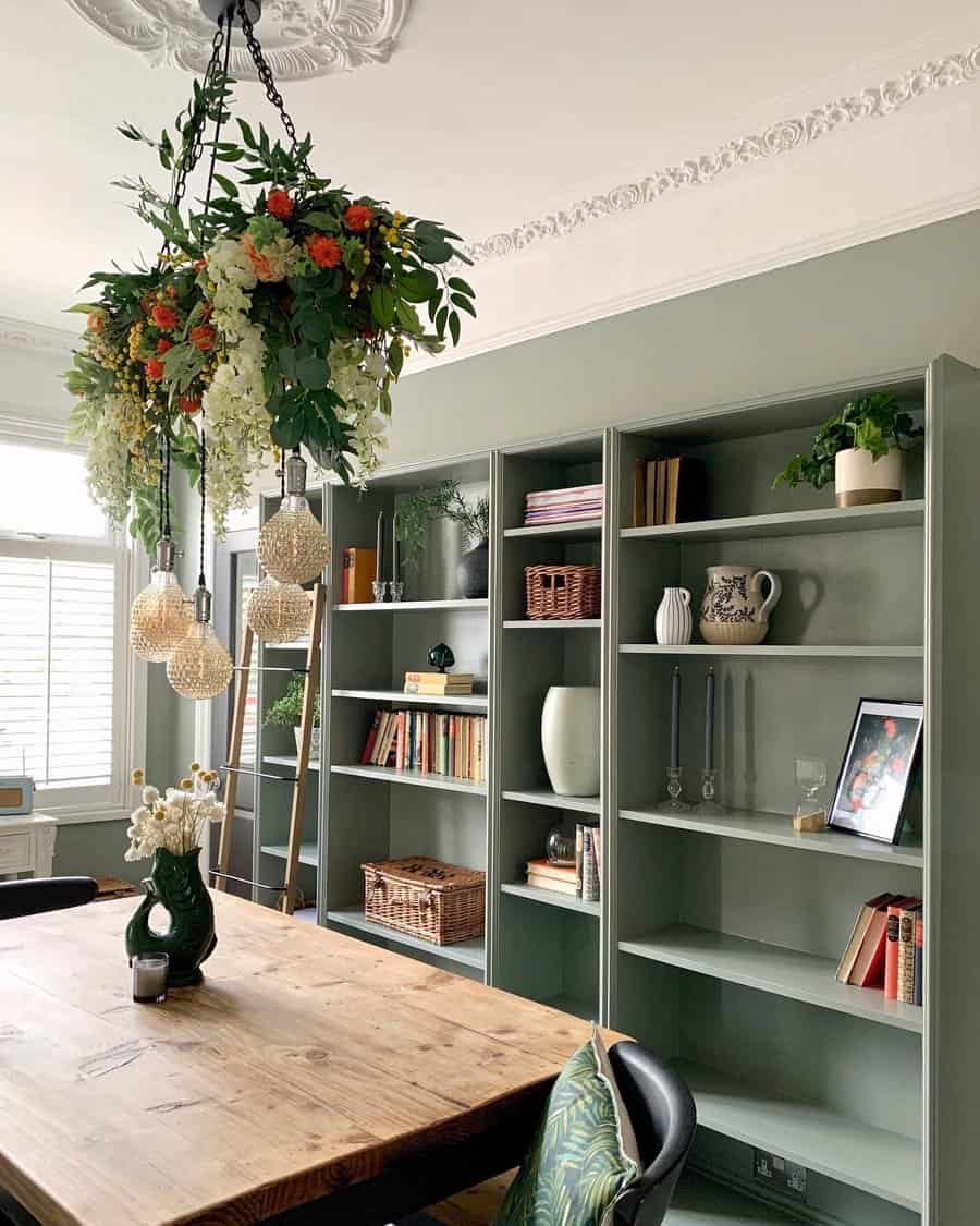 Eclectic dining room with floral chandelier and bookshelves