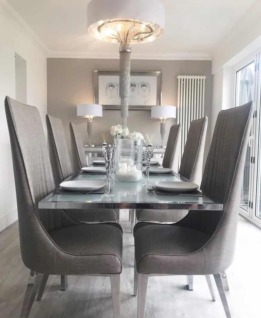 Luxurious dining room with crystal drum chandelier and grey chairs