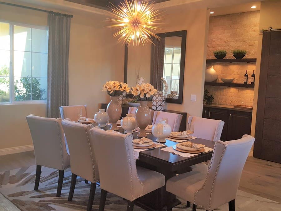 Warm dining room with starburst chandelier and elegant decor