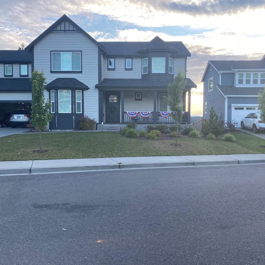 Suburban home with festive bunting and landscaped yard
