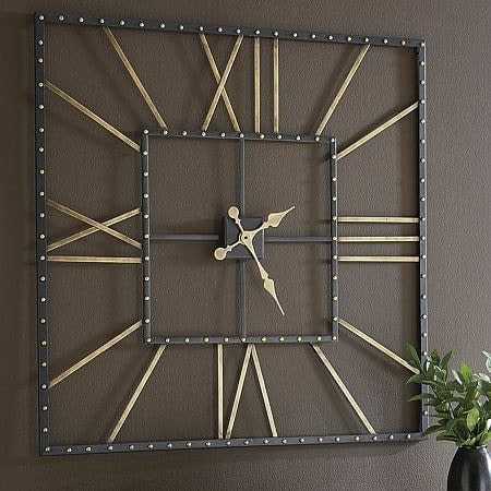 A square wall clock with Roman numerals