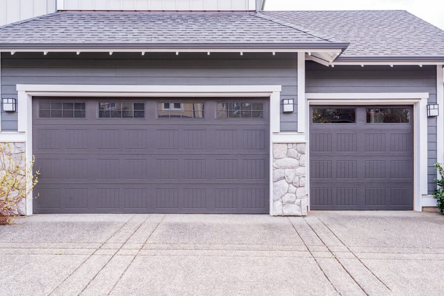 Gray Garage Door Ideas 1 Home with double gray garage doors and stone pillar