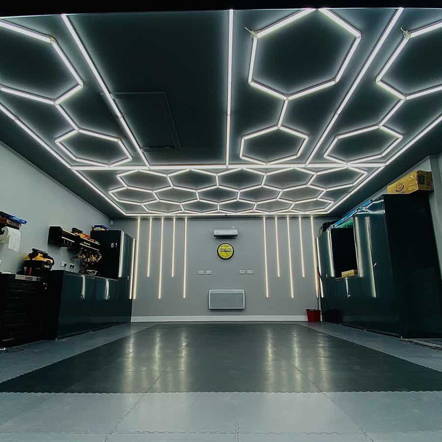 garage with light grey floor, dark grey wall, and hexagrid led light detailing