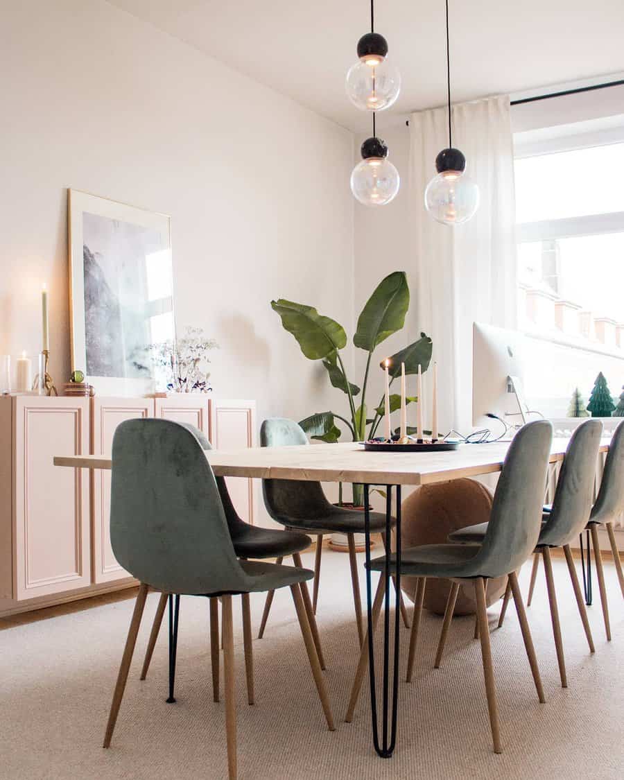 Scandinavian dining room with pendant lights and green accents