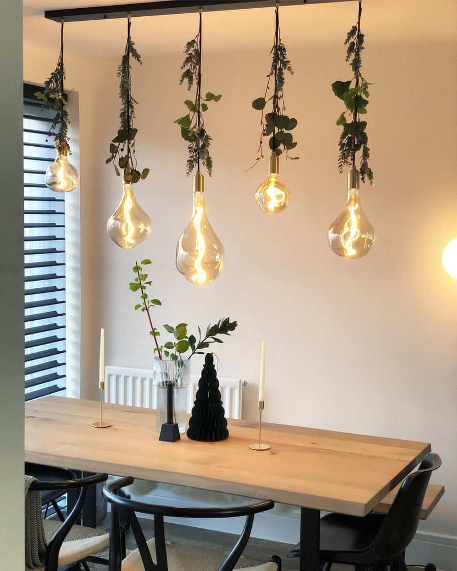 Modern dining with plant draped bulbs and minimalist decor