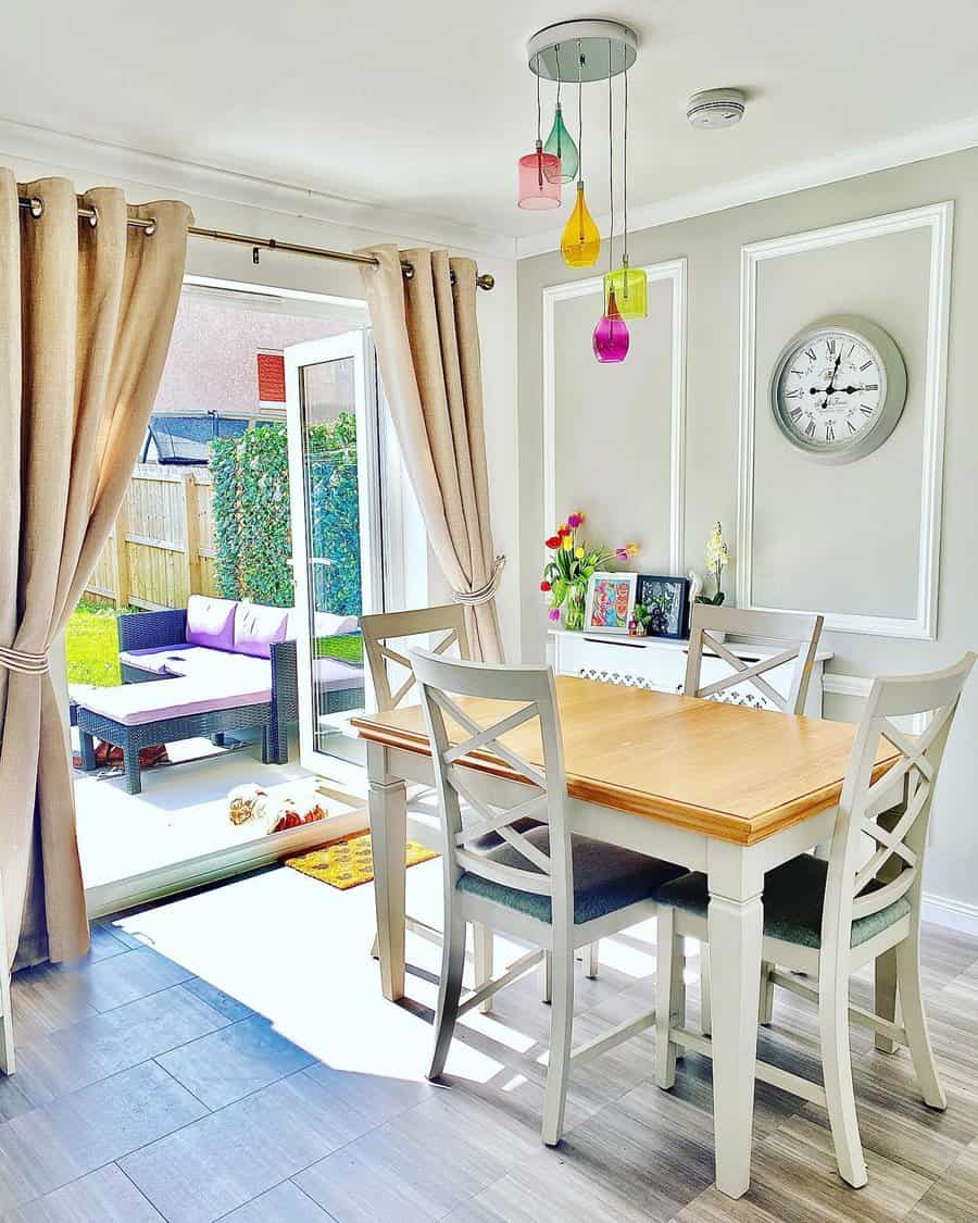 Bright dining area with colorful pendant lights and garden view