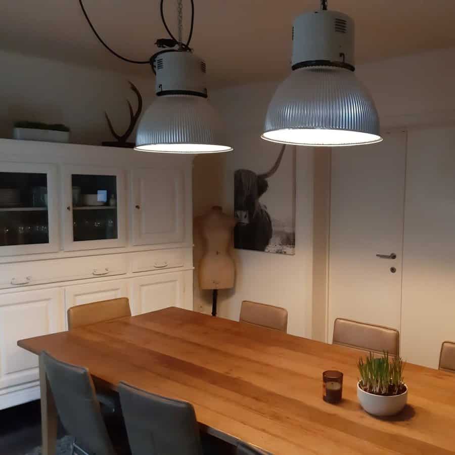 Industrial style dining with large metal pendant lights