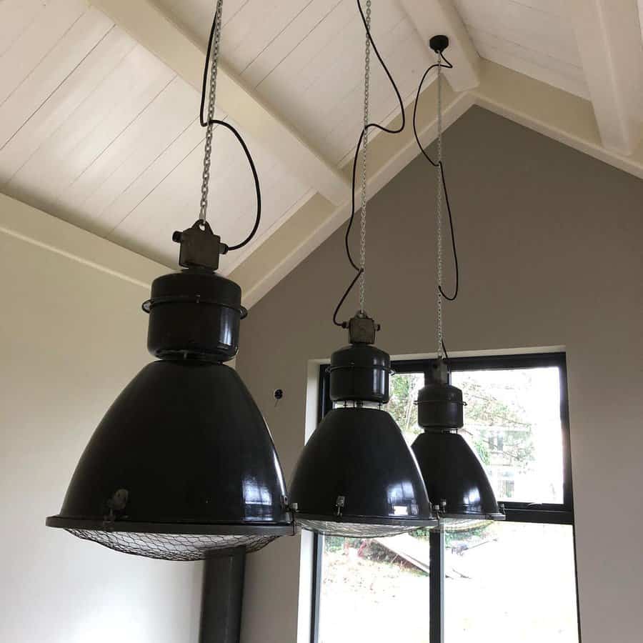 Industrial pendant lights in a vaulted ceiling dining room