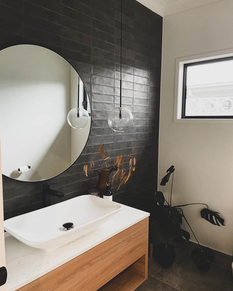 Contemporary bathroom with pendant lights and dark tiles