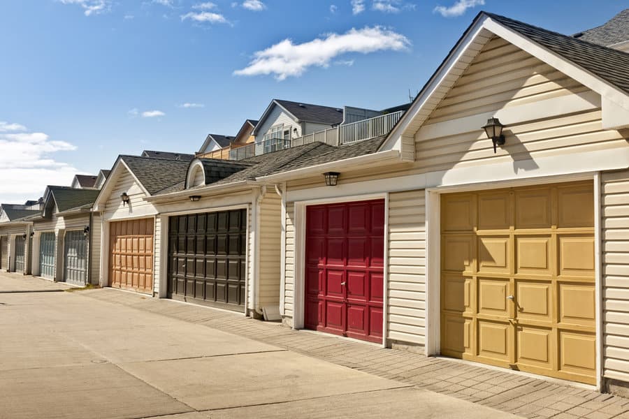 Painted Garage Door Ideas 2 Row of houses with colorful garage doors under blue sky