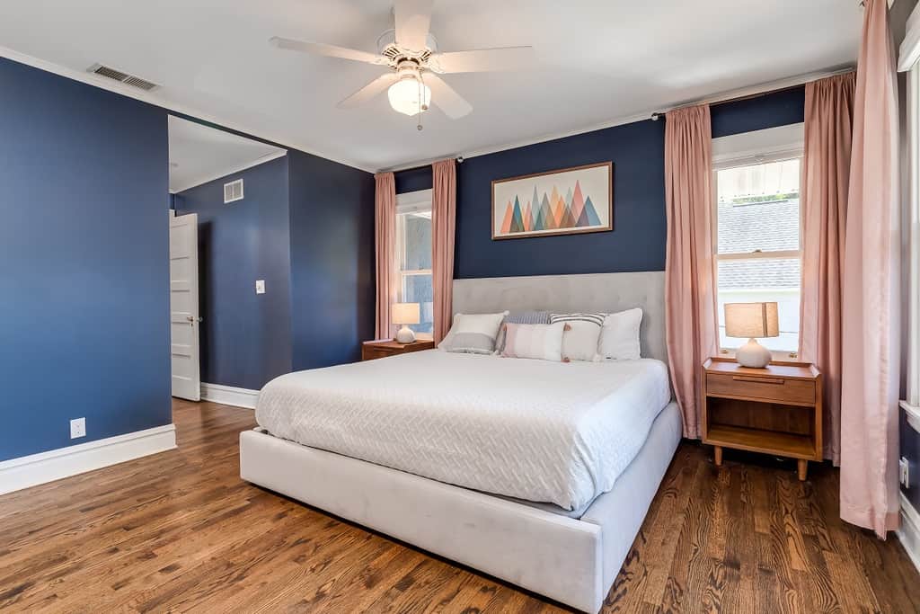 Bright room with blue walls and abstract art