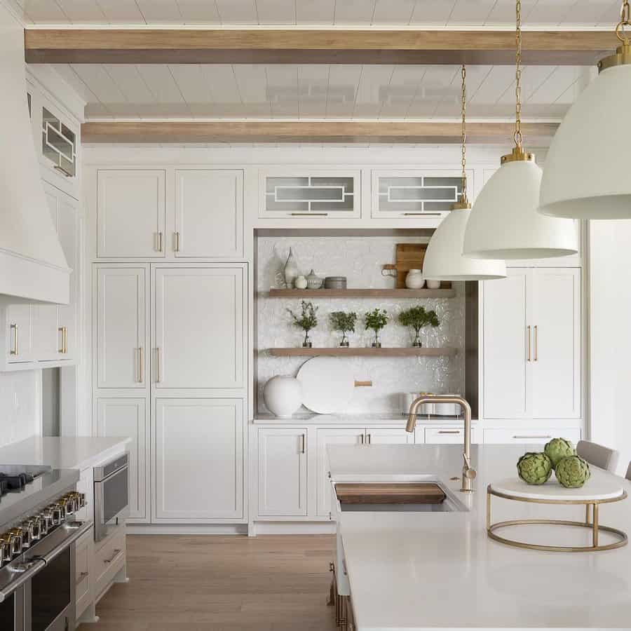 White kitchen cabinets with gold metalware