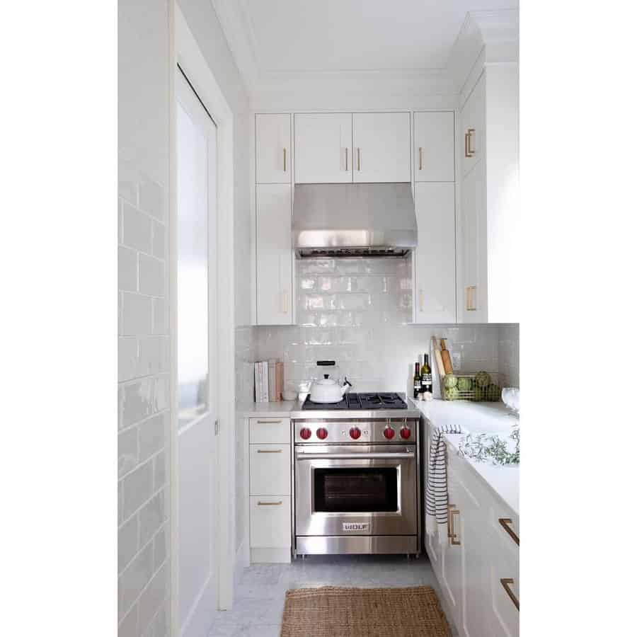 White kitchen cabinets with gold metalware