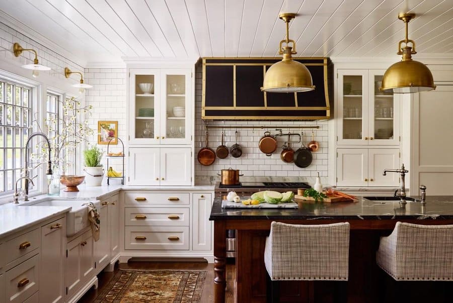 White kitchen cabinets with gold metalware