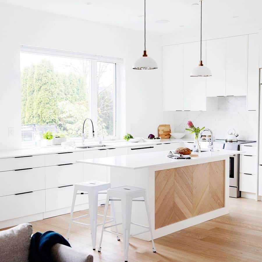 White cabinets with wood kitchen island and flooring