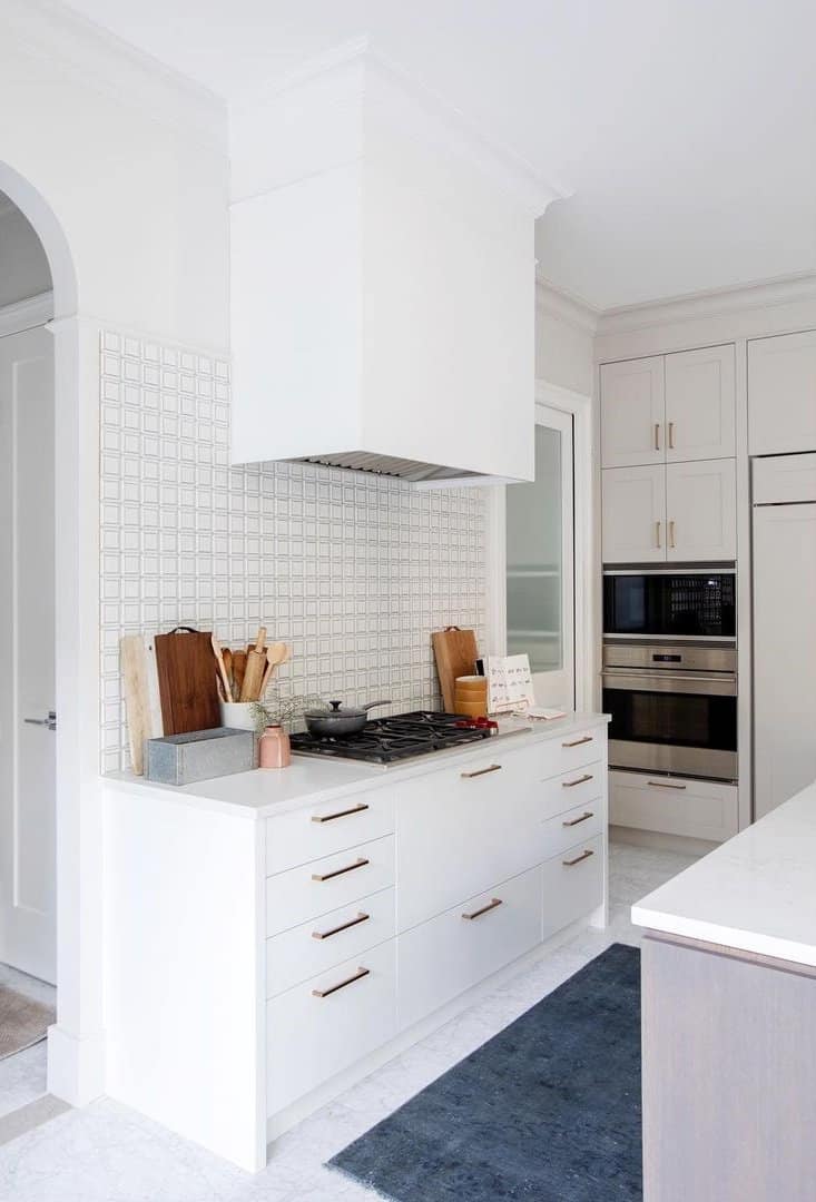 White kitchen cabinets with gold metalware