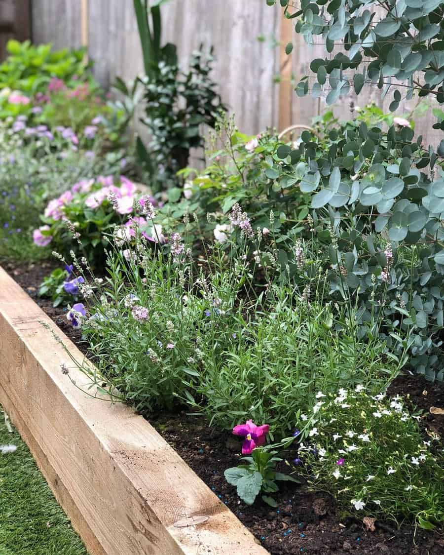 Raised flower bed along a fence