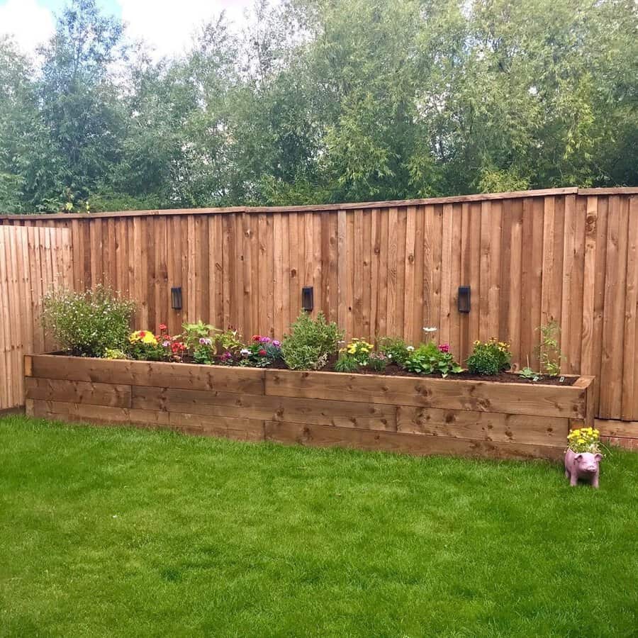 Raised flower bed along a fence