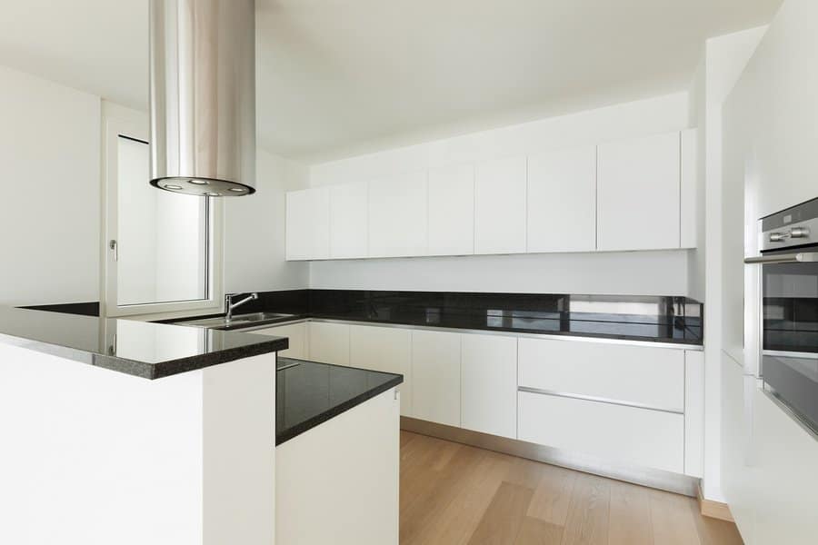 White cabinets with black countertop