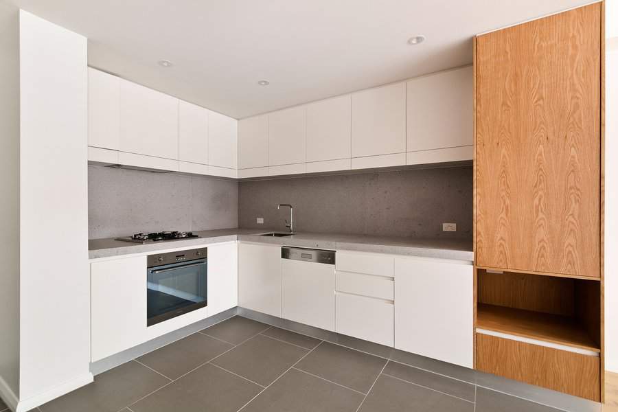 White kitchen cabinets with wood and concrete accents 