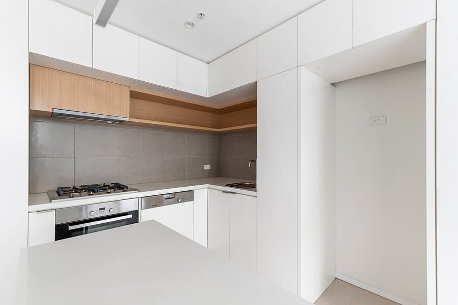 White kitchen cabinets with wood and concrete accents 