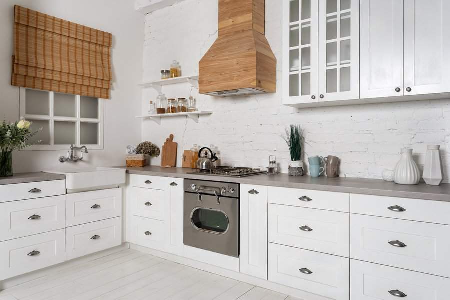 White kitchen with wood range hood