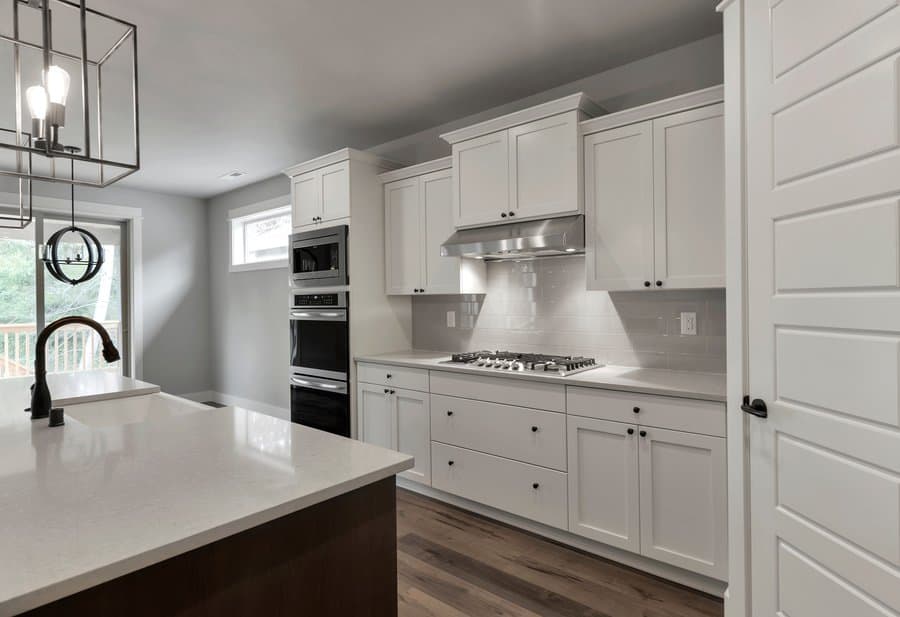 White kitchen cabinets with subway tile backsplash
