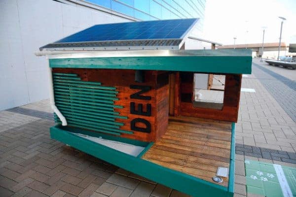 Modern green dog house with a solar panel