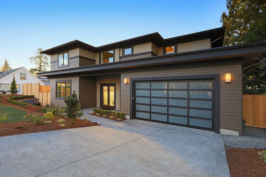Modern home with glass paneled garage door