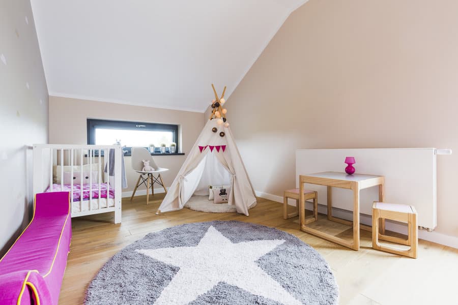 Spacious child's room with teepee and star patterned rug